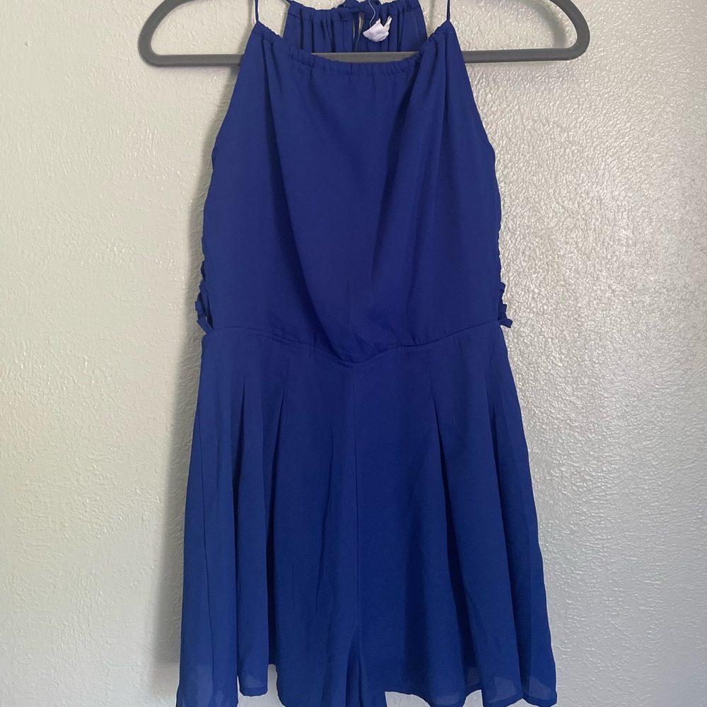 Blue sleeve-less romper with side details & open back